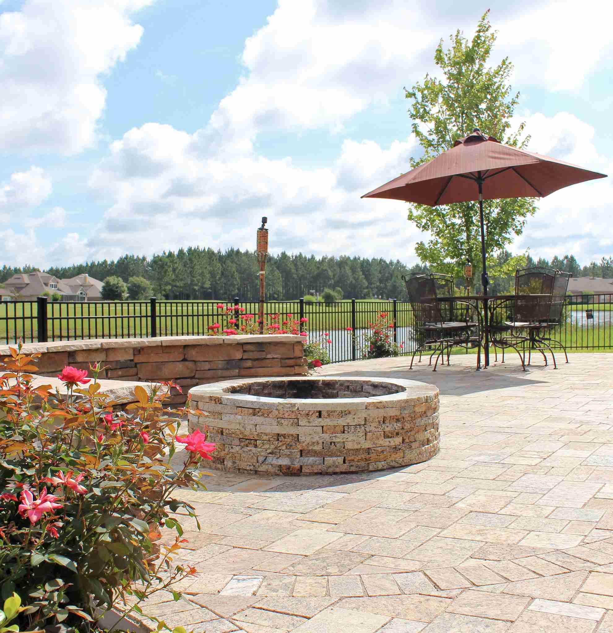 Paver patio with stone fire pit and seating area