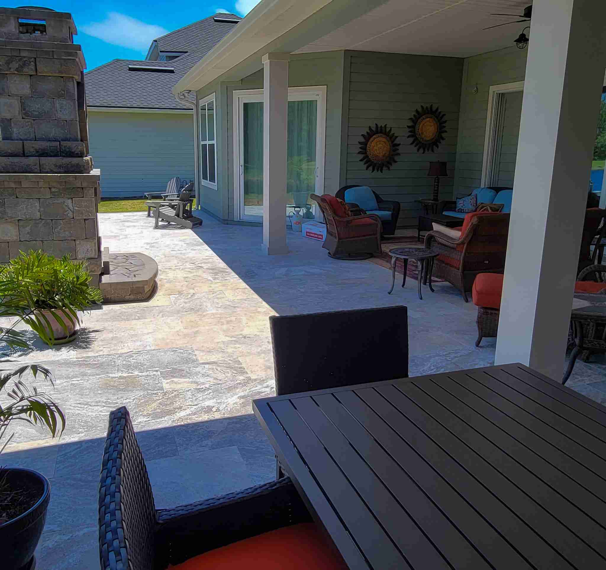 Covered patio with outdoor fireplace and seating area