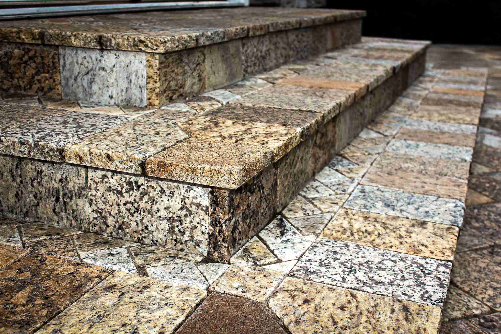 Natural granite stone steps with herringbone paver landing