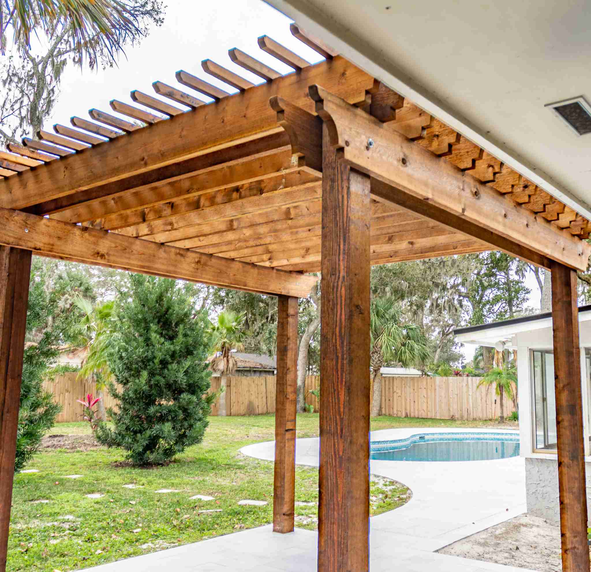 Cedar pergola with walkway and pool in background