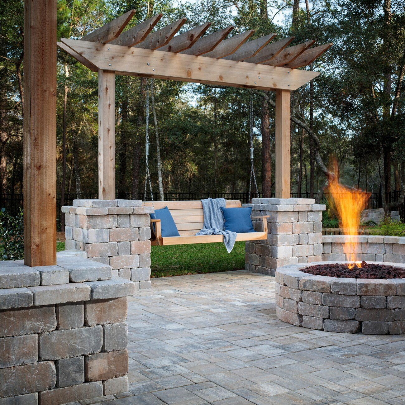 Pergola with porch swing and stone fire pit