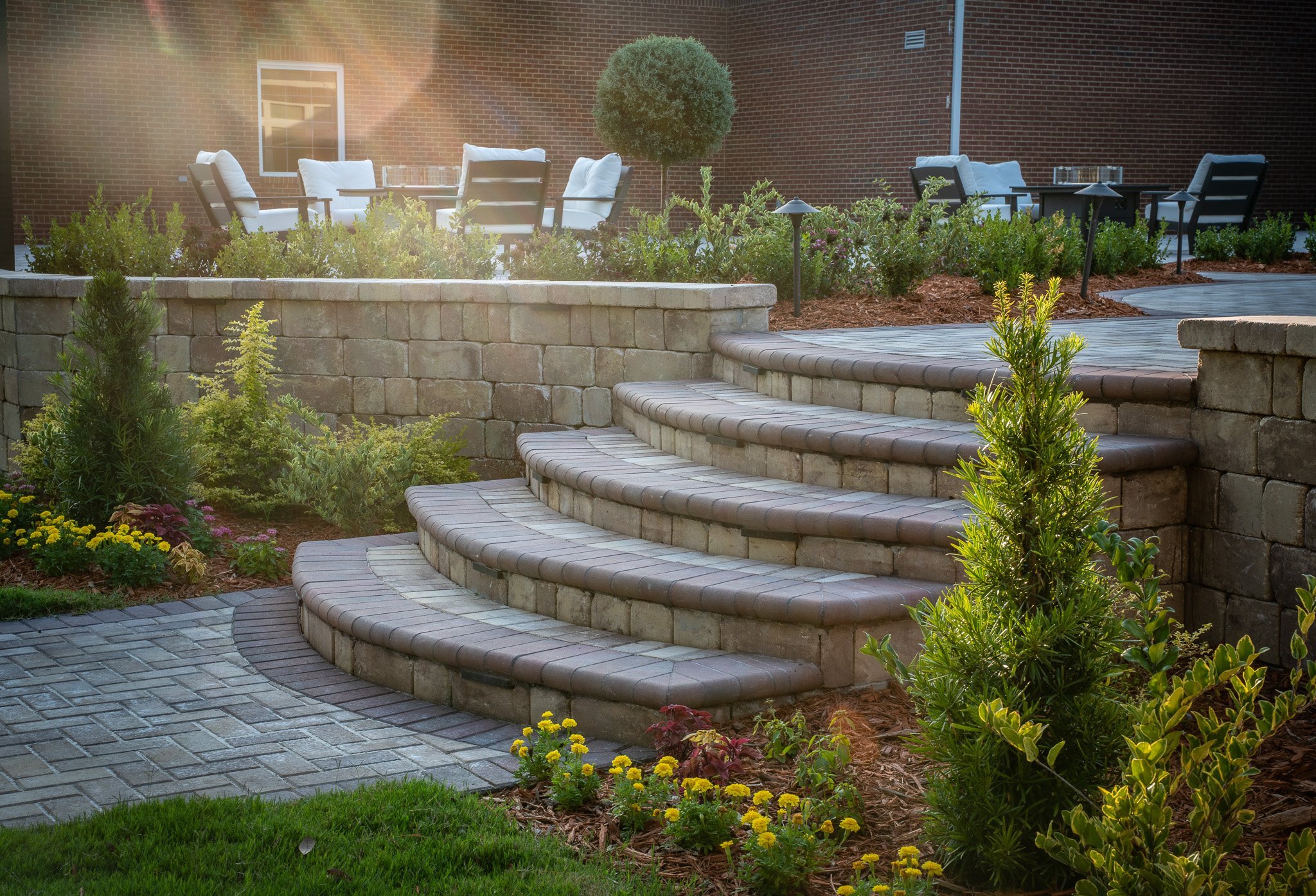 Curved paver steps with retaining walls and landscaping